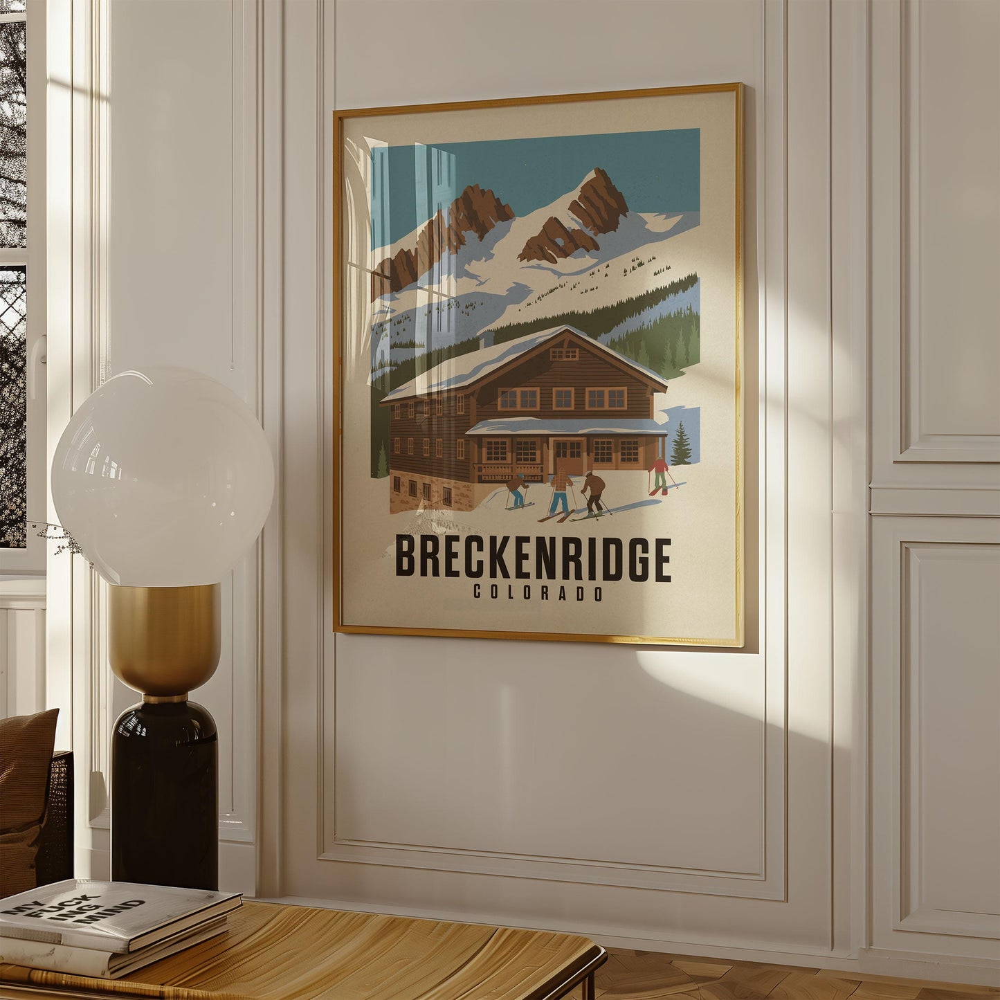 a picture of a ski lodge hangs on a wall
