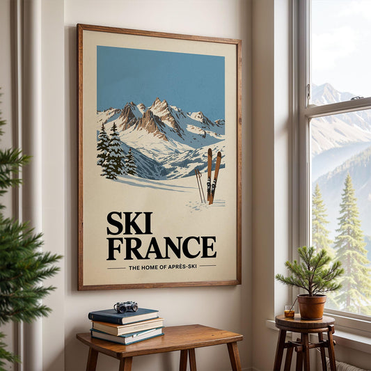 A framed poster of a snowy mountain landscape with ski equipment is displayed on the wall, with a small table and a potted plant in the foreground.