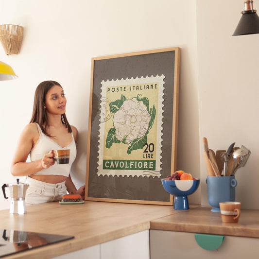 a woman standing in a kitchen with a cup of coffee