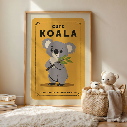 a framed poster of a koala bear with a yellow background and black text, accompanied by a woven basket containing two stuffed koala bears.