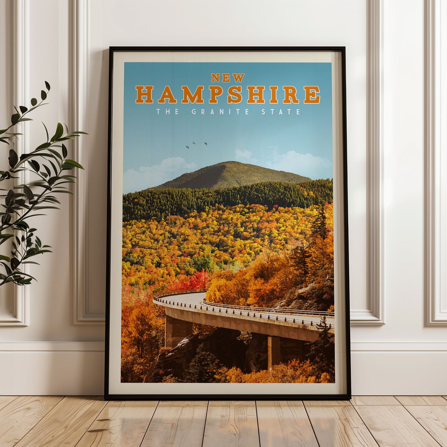 The image is a framed poster of a scenic autumn landscape in New Hampshire, featuring a winding road, a mountain, and colorful foliage.
