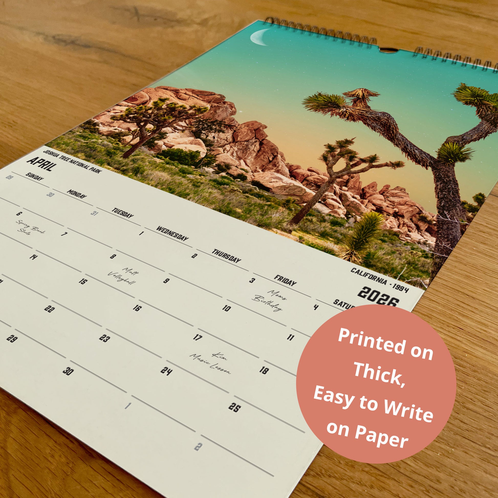 A wall calendar with a desert landscape image on the cover, featuring a crescent moon and a rocky mountain backdrop.