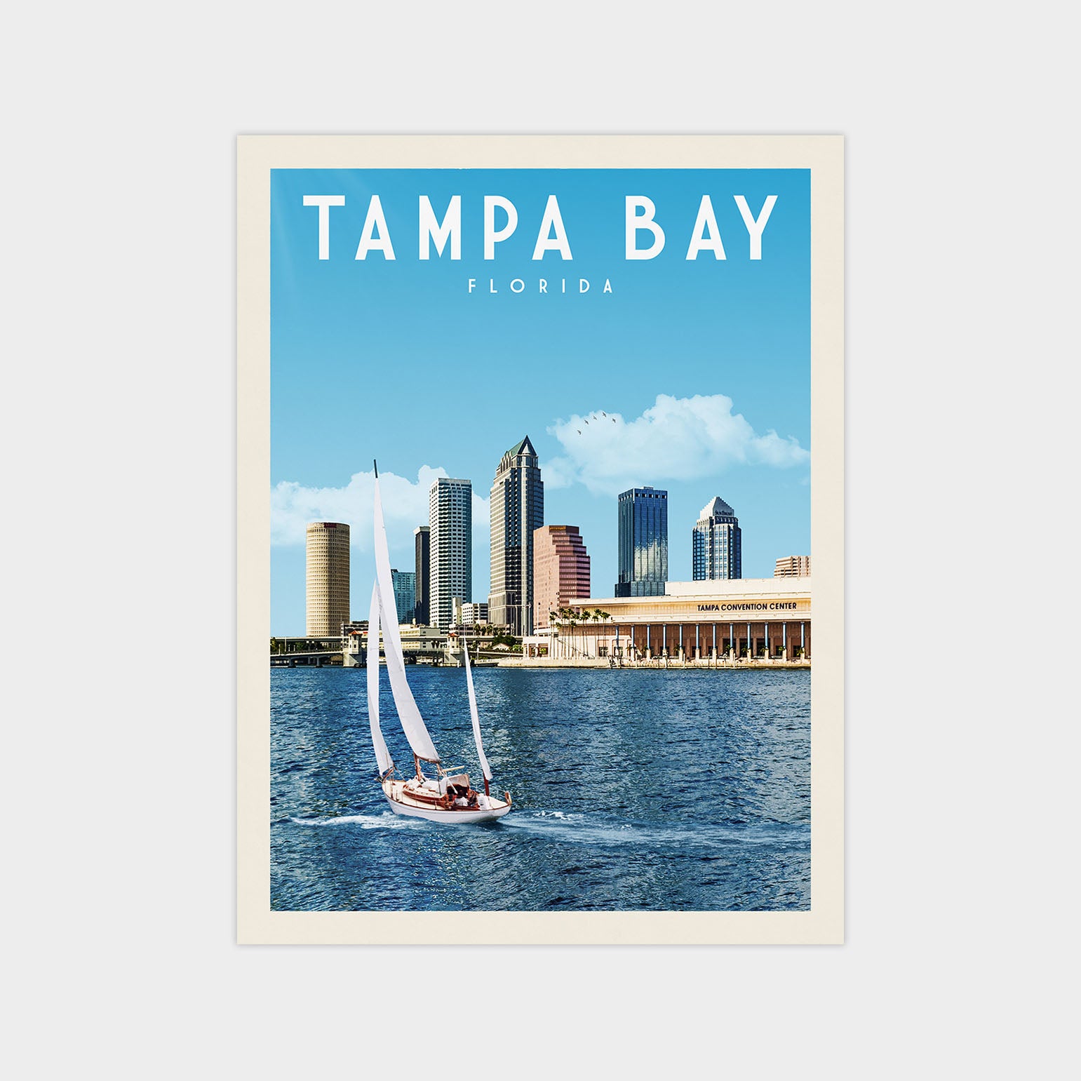 A sailboat on the water with the city skyline of Tampa Bay, Florida in the background.