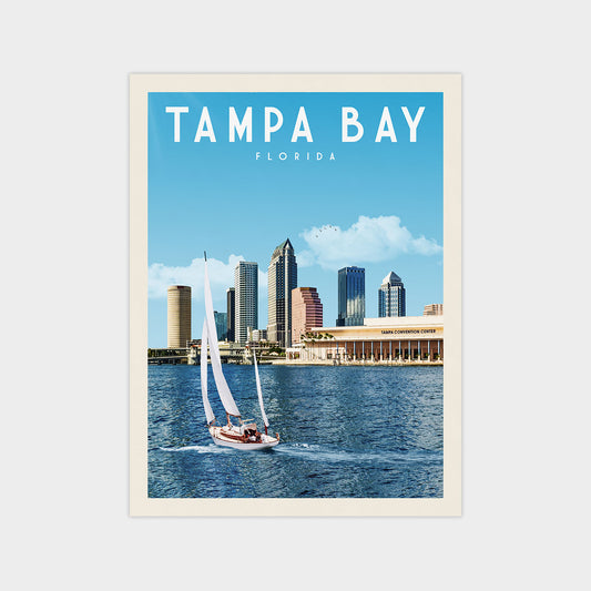 A sailboat on the water with the city skyline of Tampa Bay, Florida in the background.