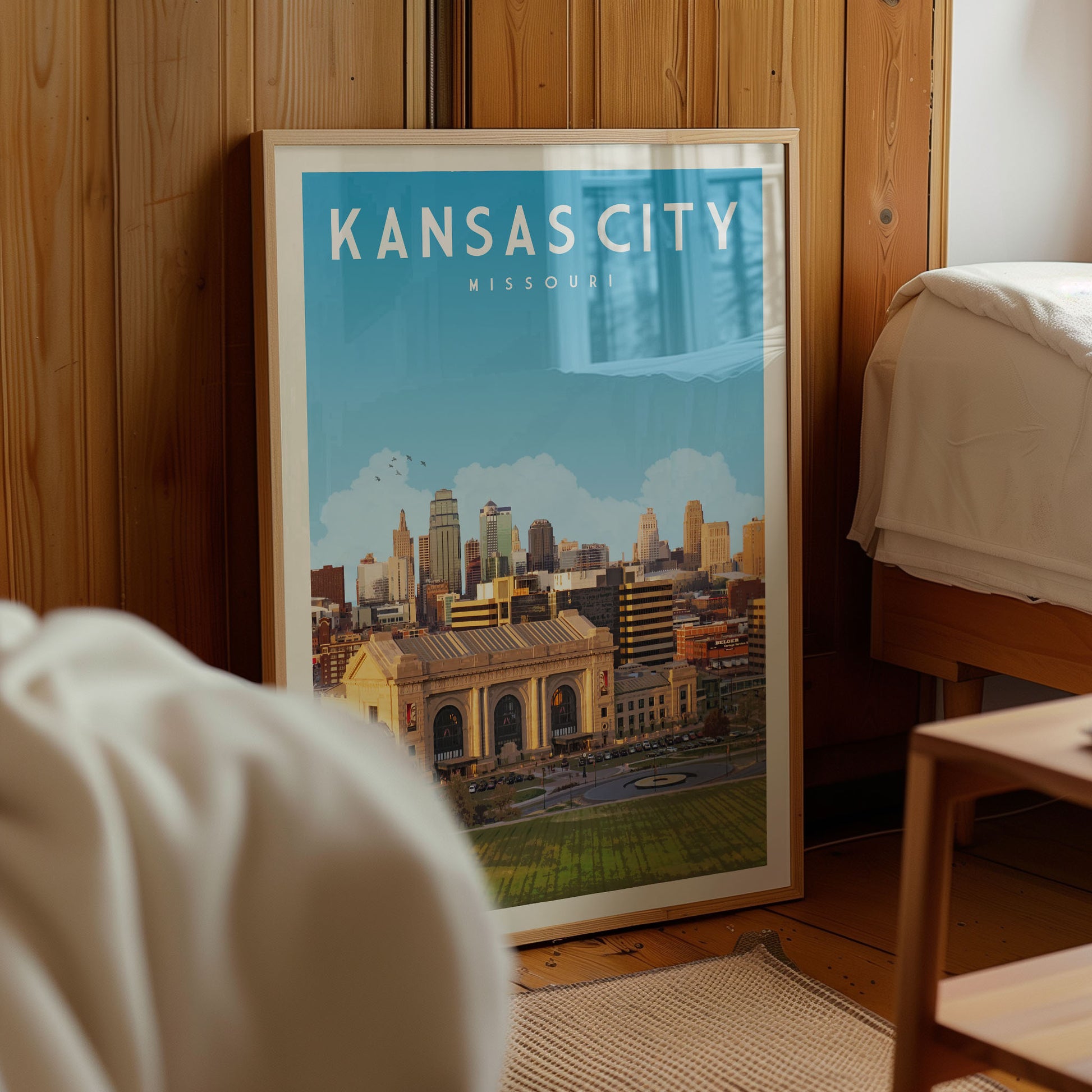 A framed poster of the Kansas City skyline is displayed in a room with wooden paneling.