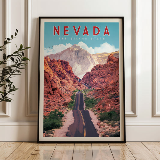 The image is a framed poster of a scenic road winding through a mountainous landscape, with the text "NEVADA THE SILVER STATE" prominently displayed.