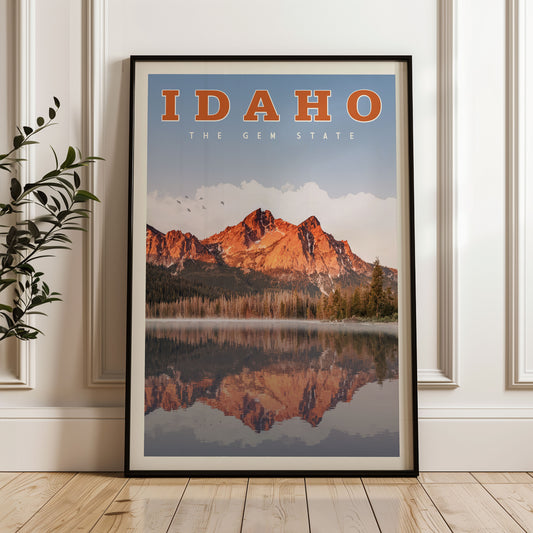 A framed poster of a scenic mountain landscape with a lake and trees, featuring the text "IDAHO THE GEM STATE" prominently displayed.