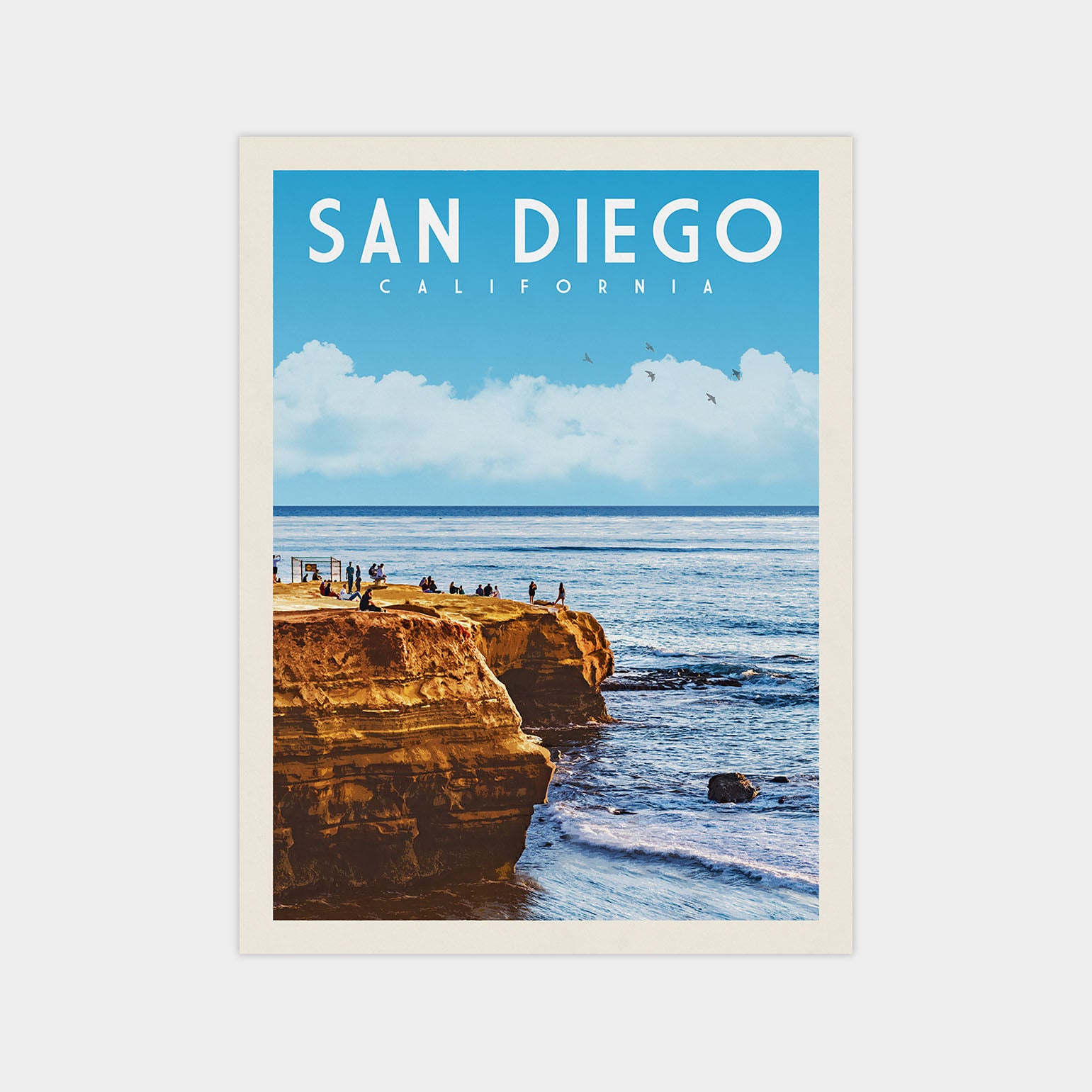 A framed poster depicting a scenic coastal landscape with cliffs, people, and a body of water, with the text "SAN DIEGO, CALIFORNIA" prominently displayed.