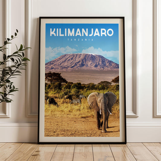 A framed poster of Kilimanjaro, the highest peak in Africa, with an elephant and zebras in the foreground.