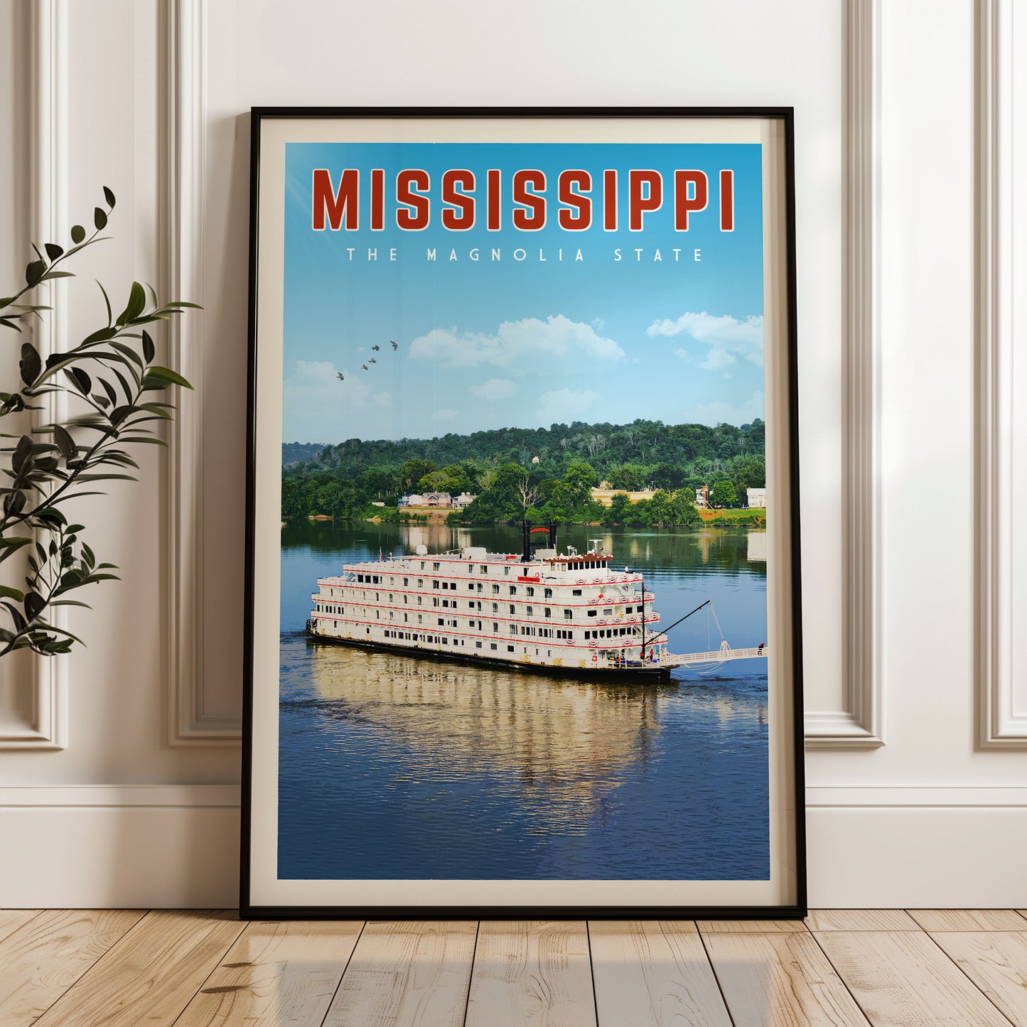 A framed poster of a large white boat on a river, with the text "MISSISSIPPI THE MAGNOLIA STATE" prominently displayed.