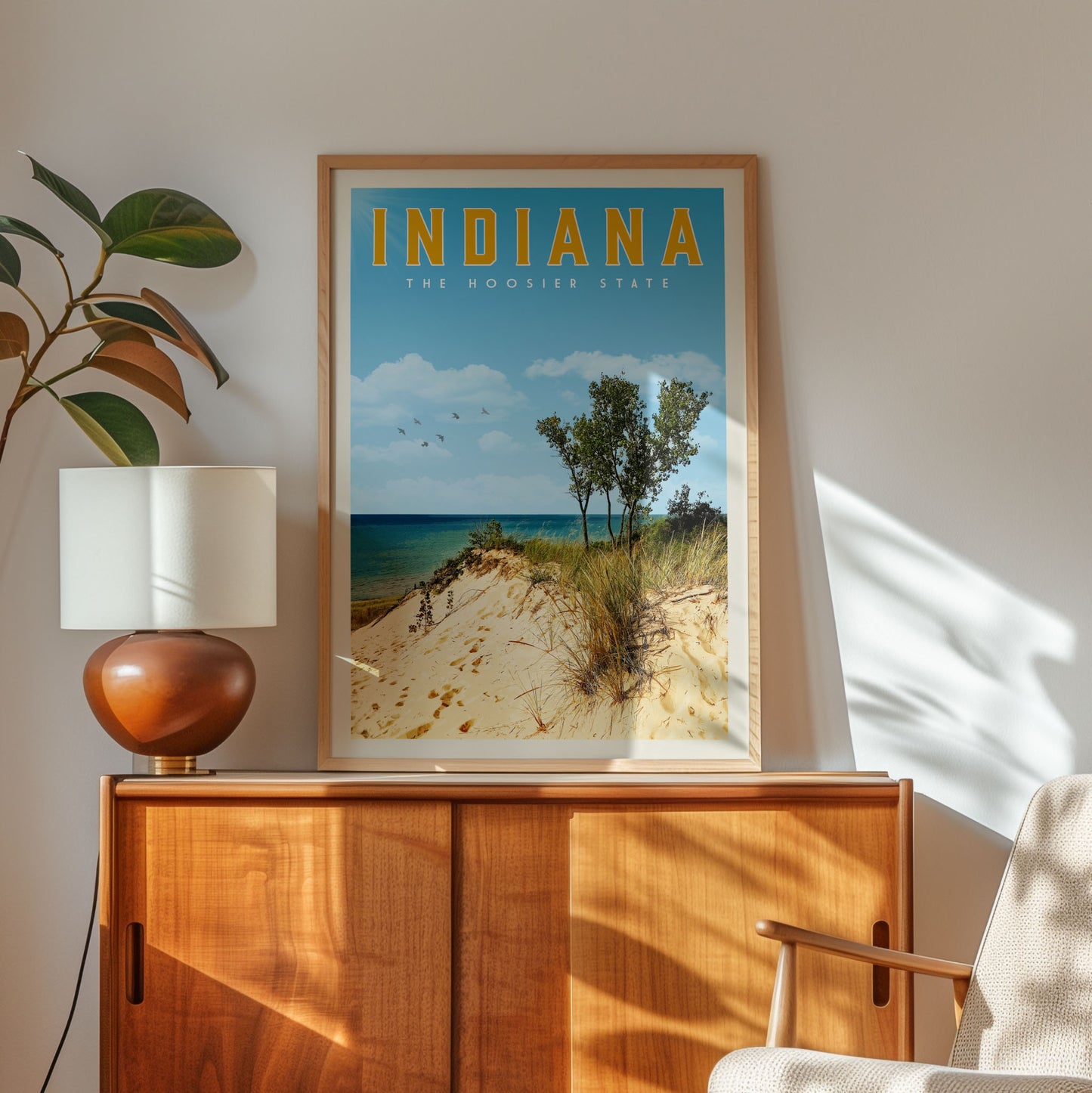 a framed poster of a beach scene with the text "INDIANA" and "THE HOOSIER STATE" displayed prominently.