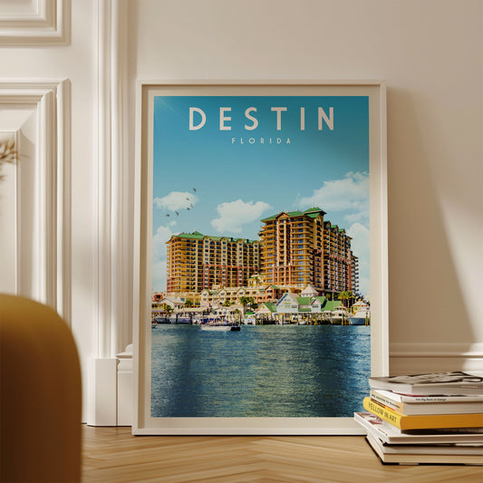 A framed poster of a large hotel complex in Destin, Florida, with a body of water in the foreground.