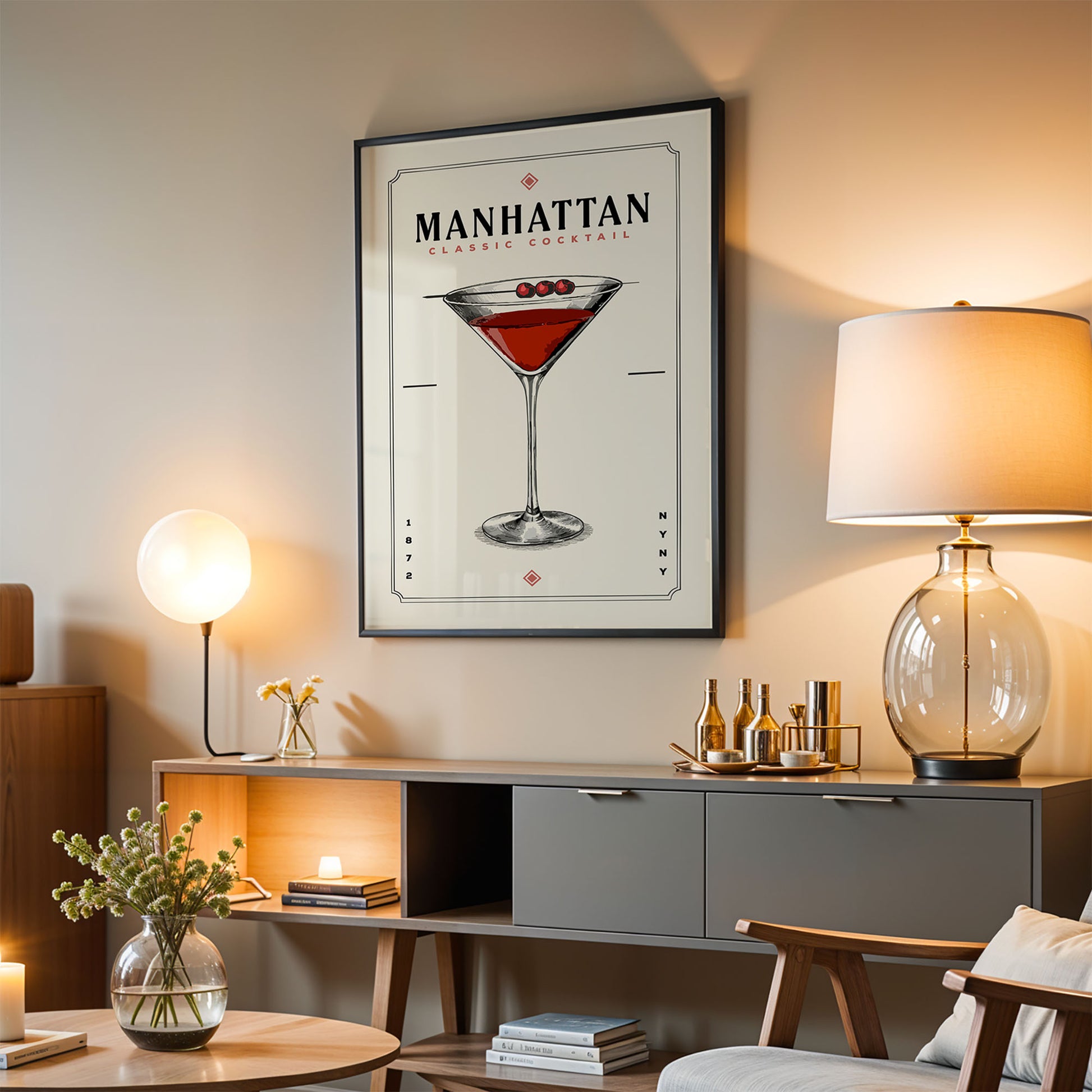 a living room with a framed poster of a Manhattan cocktail hanging on the wall, a wooden sideboard with a glass lamp, a wooden chair, and a small table with a vase of flowers.