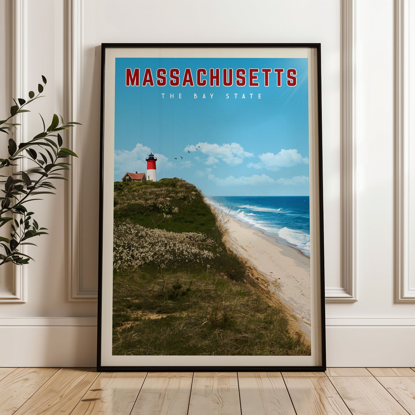 A framed poster of a lighthouse on a cliff overlooking a beach and ocean, with the text "MASSACHUSETTS THE BAY STATE" displayed prominently.