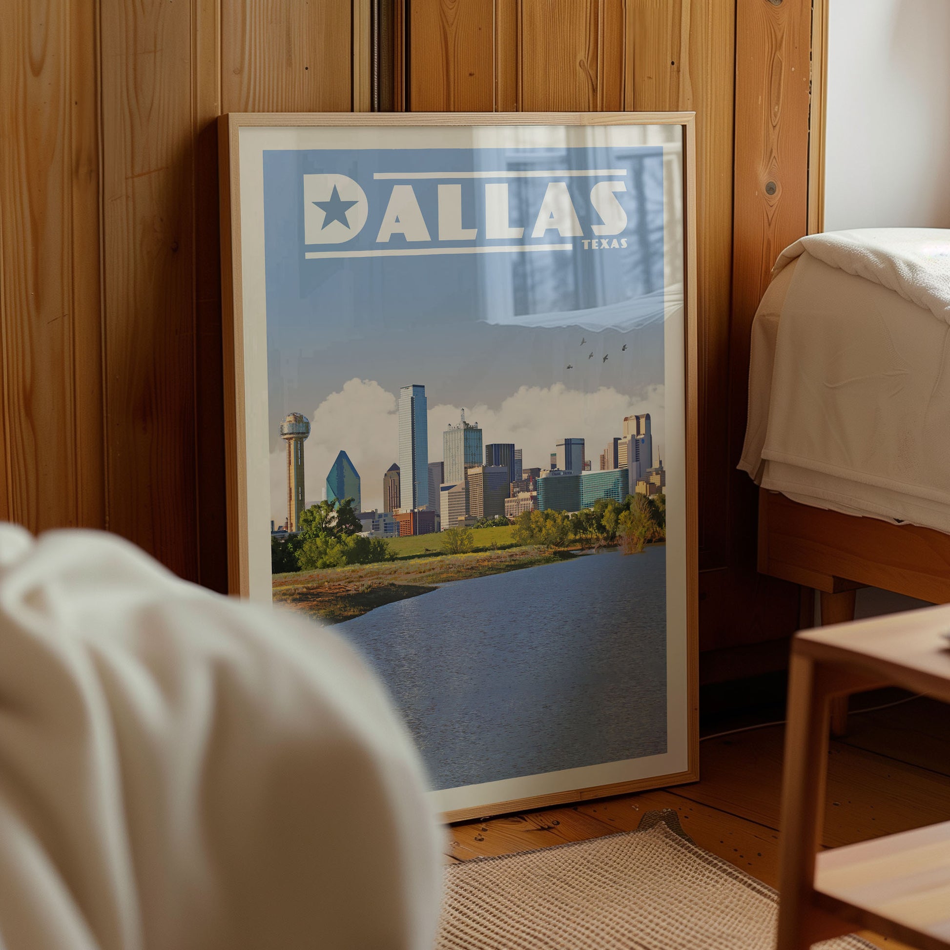 A framed poster of the Dallas skyline is displayed in a room with wooden paneling.