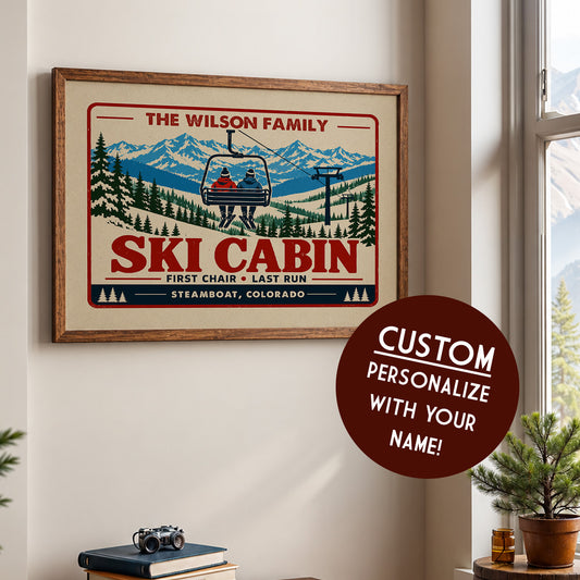 a framed poster of a ski cabin with a ski lift, along with a circular sticker that says "CUSTOM PERSONALIZE WITH YOUR NAME!"