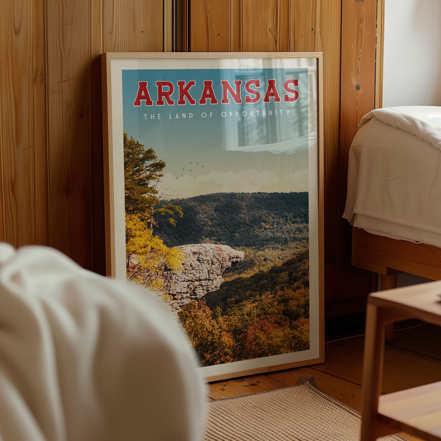 A framed poster of a scenic mountain landscape with the text "ARKANSAS THE LAND OF OPPORTUNITY" prominently displayed.