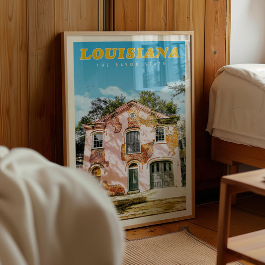 A framed poster of a house in Louisiana, with the text "LOUISIANA THE BAYOU STATE" prominently displayed.