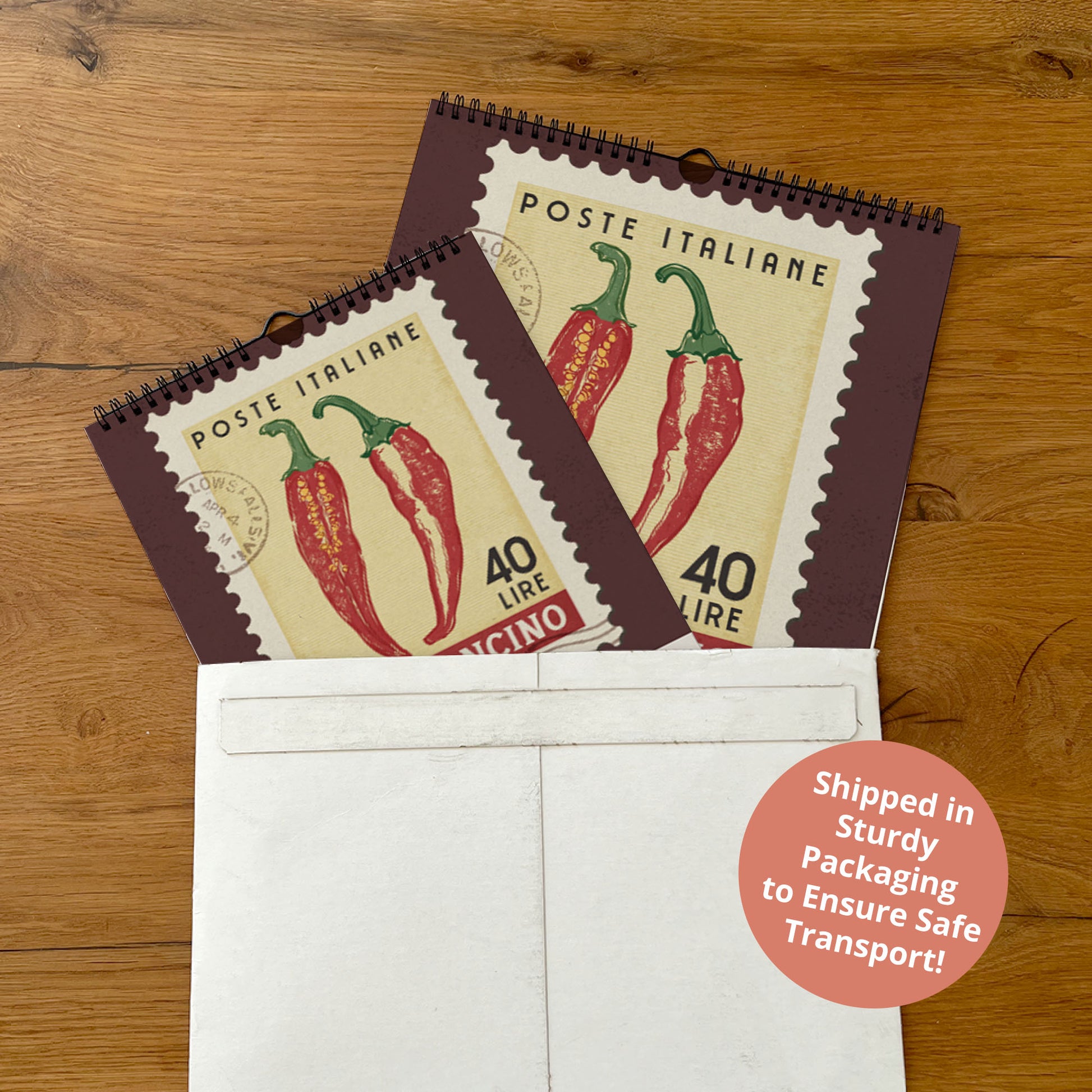 two red chili peppers, which appear to be postage stamps, placed inside a white envelope on a wooden surface.