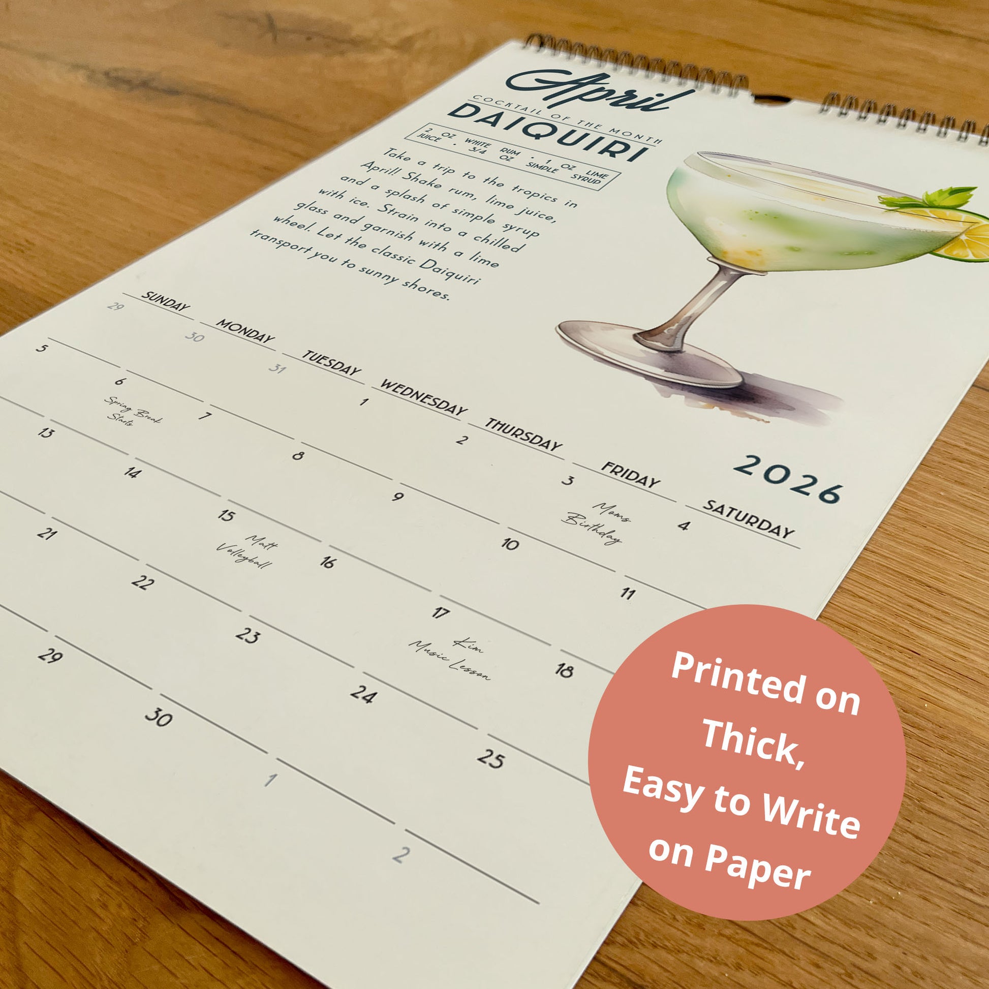 A wall calendar for the month of April, featuring a page with a picture of a cocktail and a list of days with corresponding events or activities.