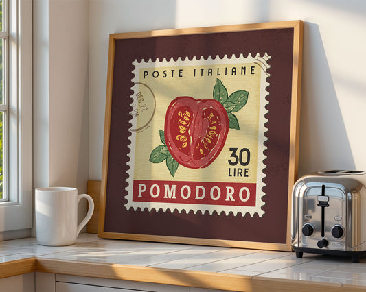 a framed picture of a tomato on a counter