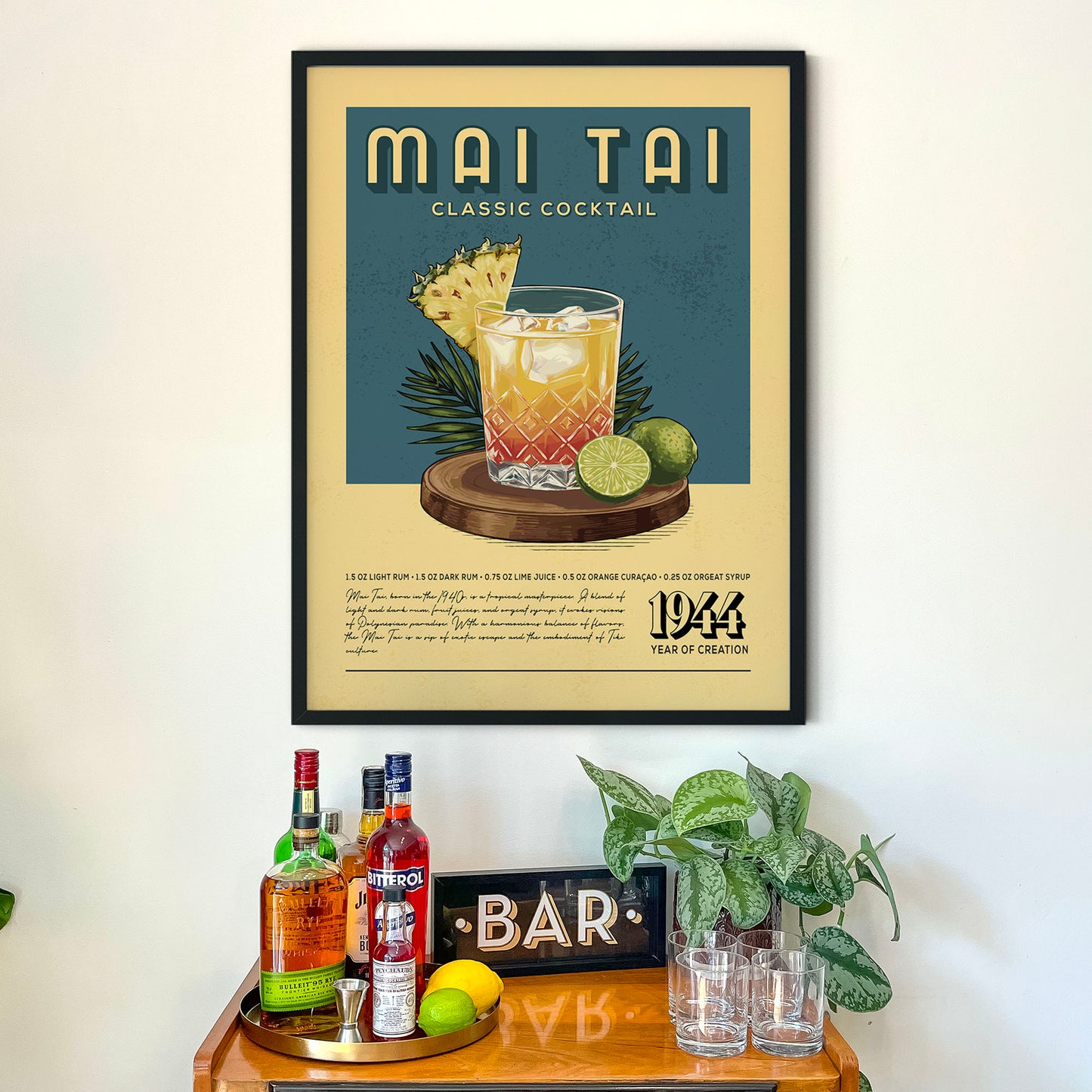 a framed poster of a classic cocktail called "Mai Tai" hanging on a wall above a wooden bar counter with various liquor bottles and glasses.