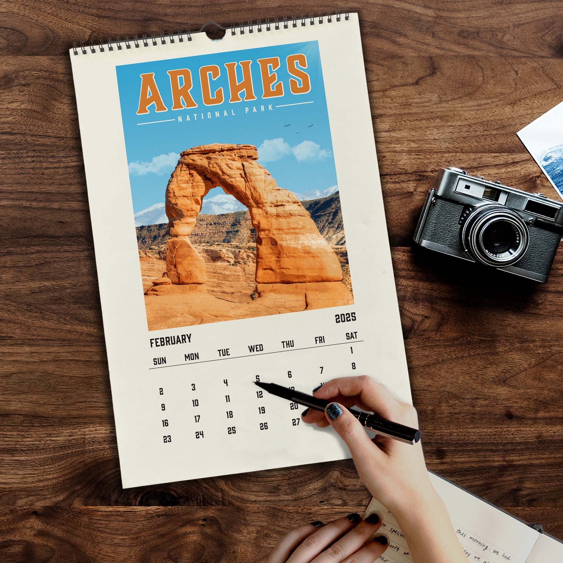 a person holding a pen and writing on a calendar