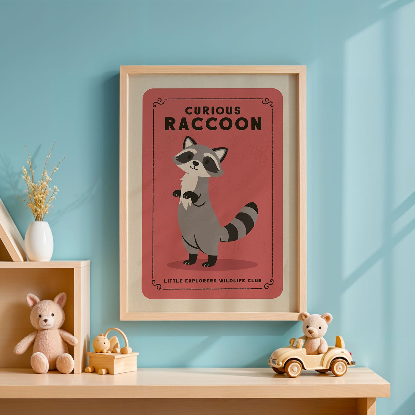 a framed poster of a raccoon on a wall, with a wooden shelf below it holding a stuffed animal and a toy car.