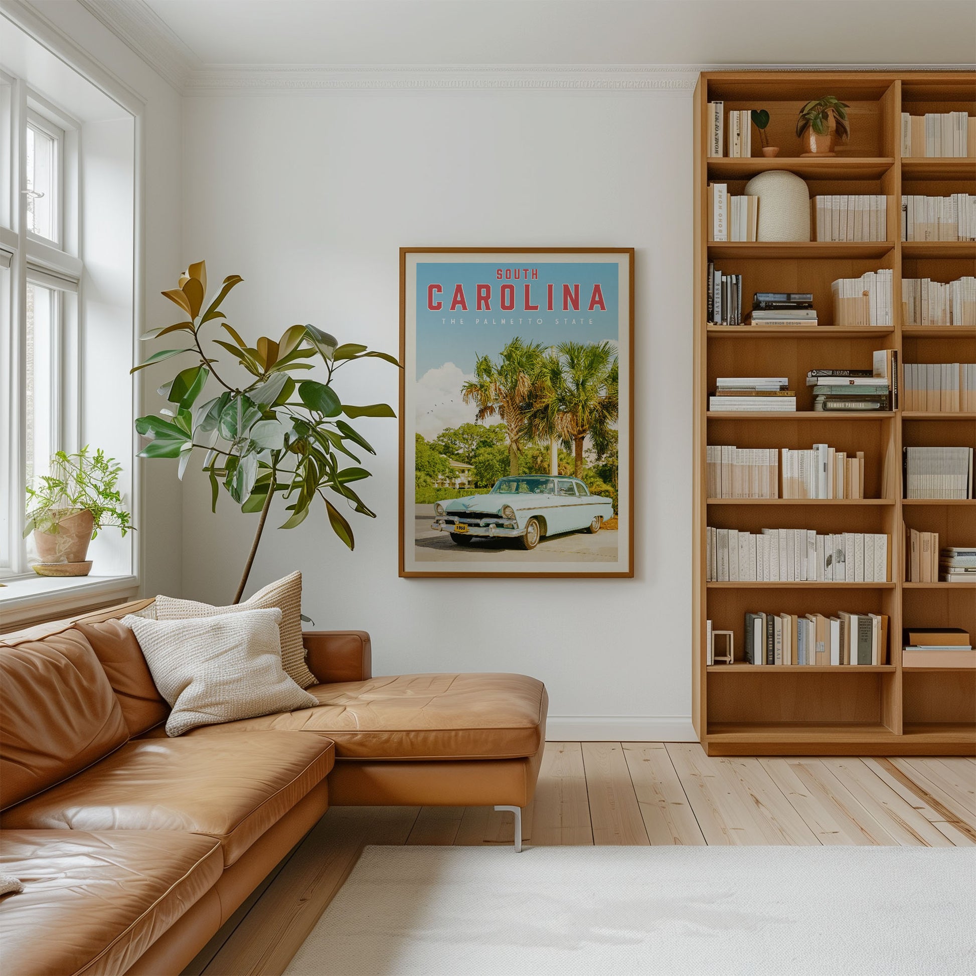a cozy living room with a large bookshelf filled with books, a comfortable leather couch, and a framed poster of a car on the wall.