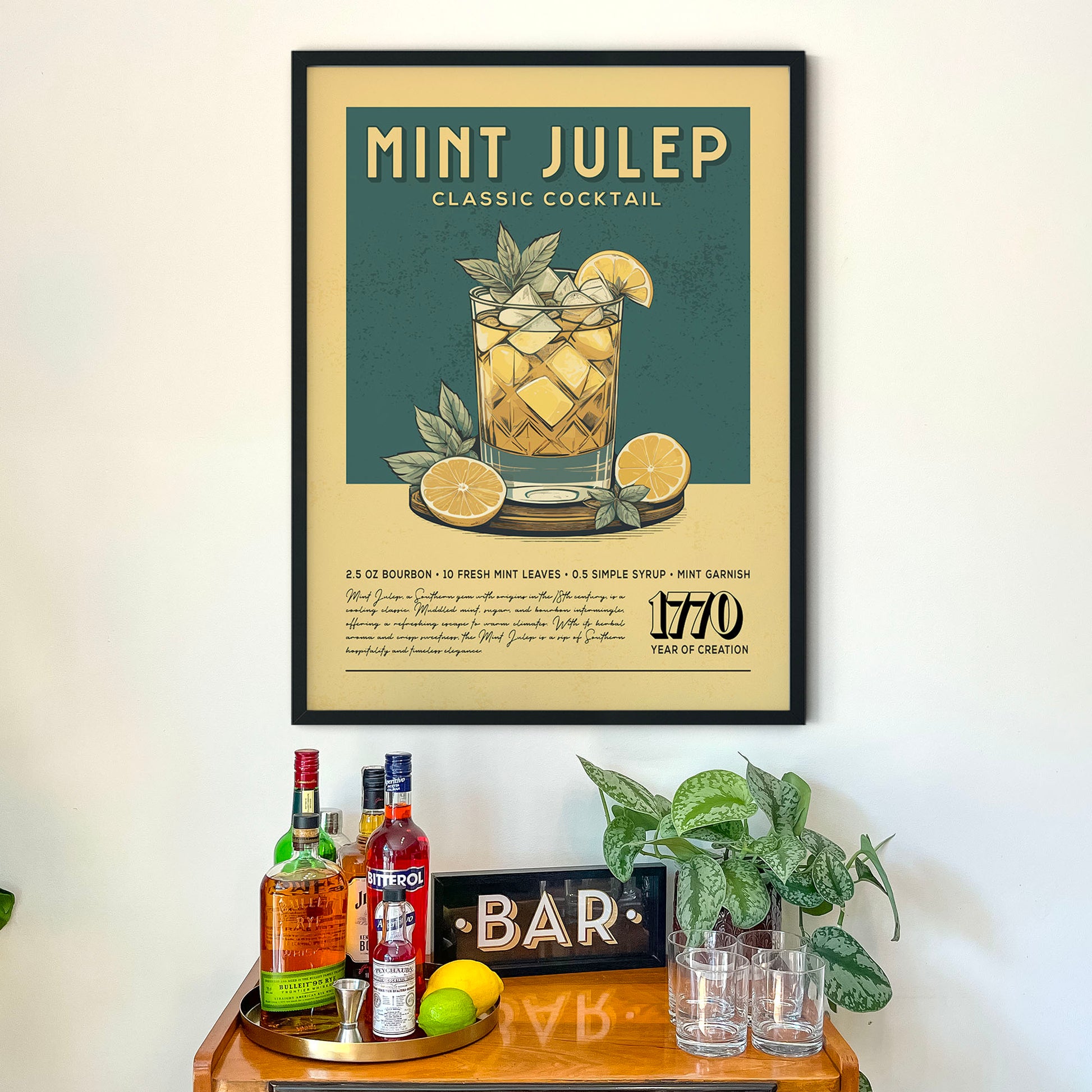 a framed poster of a mint julep cocktail hanging on a wall above a wooden bar counter with various liquor bottles and glasses.