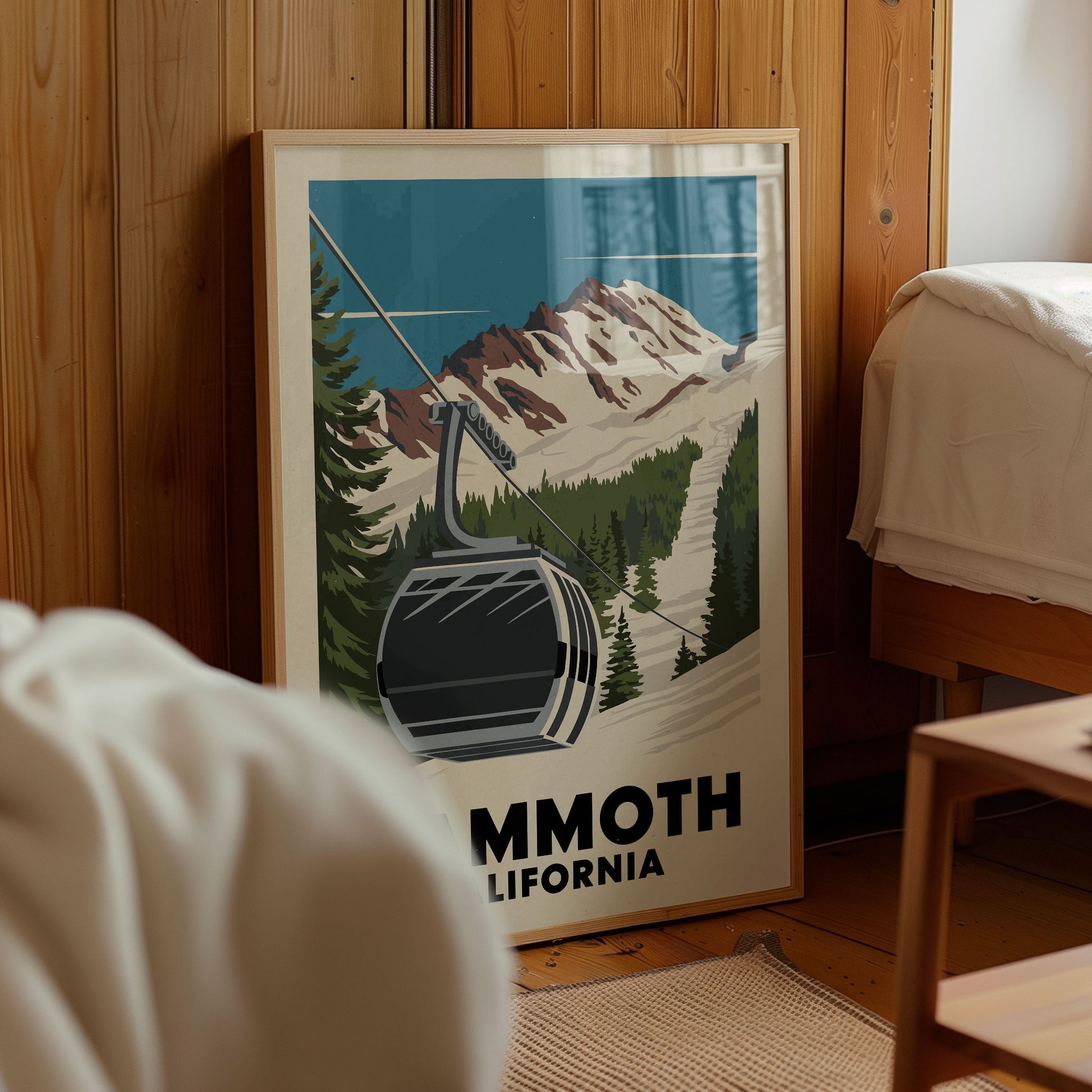 A framed poster of a ski lift in a mountainous landscape, with the text "Mmoth, California" prominently displayed.