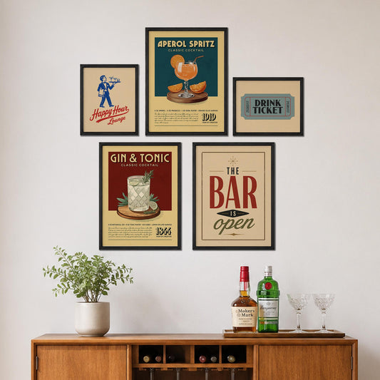 a wall display with framed vintage advertisements for drinks and a bar, along with a wooden cabinet displaying bottles of alcohol and glasses.