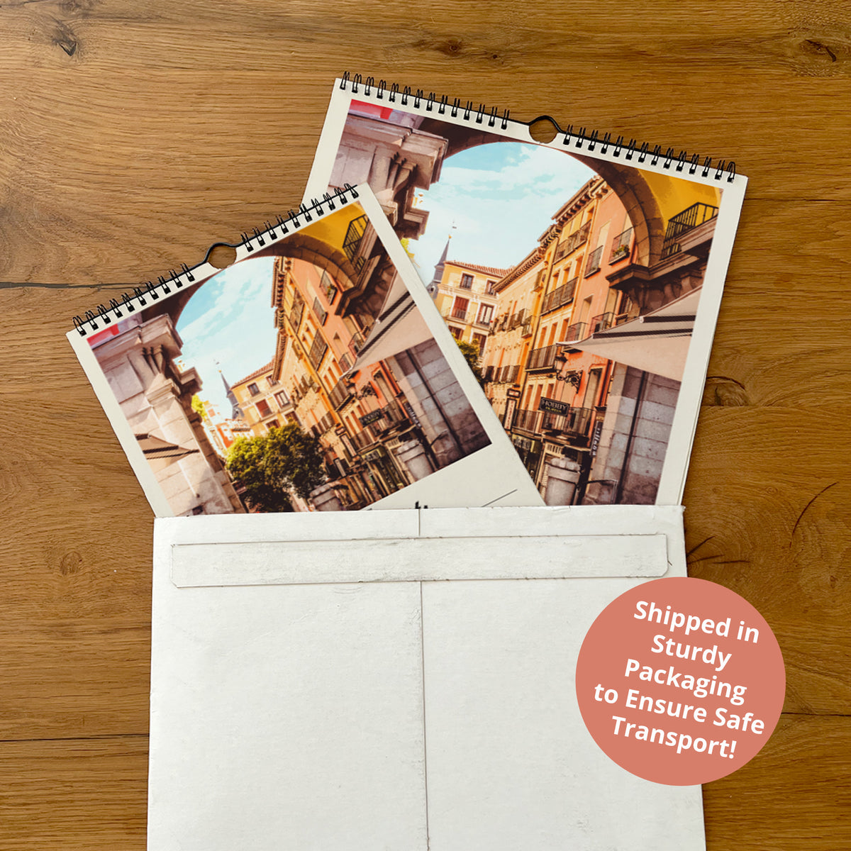 two spiral-bound photo frames with a cityscape photograph inside, placed in an envelope.
