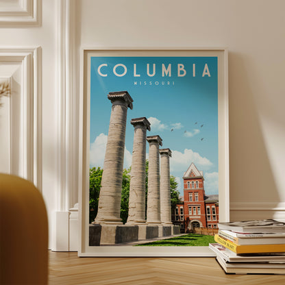 A framed poster of the historic Columbia University in Missouri, featuring the iconic columns of the university building against a blue sky with birds in flight.