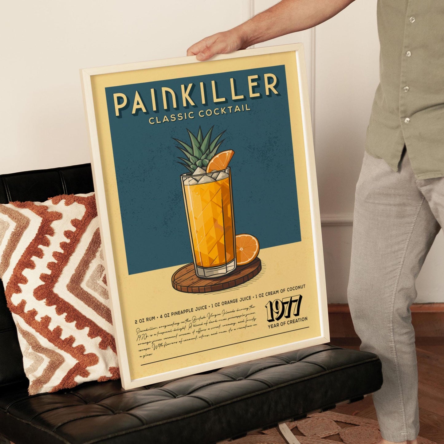 A person is holding up a framed poster advertising a Painkiller classic cocktail.