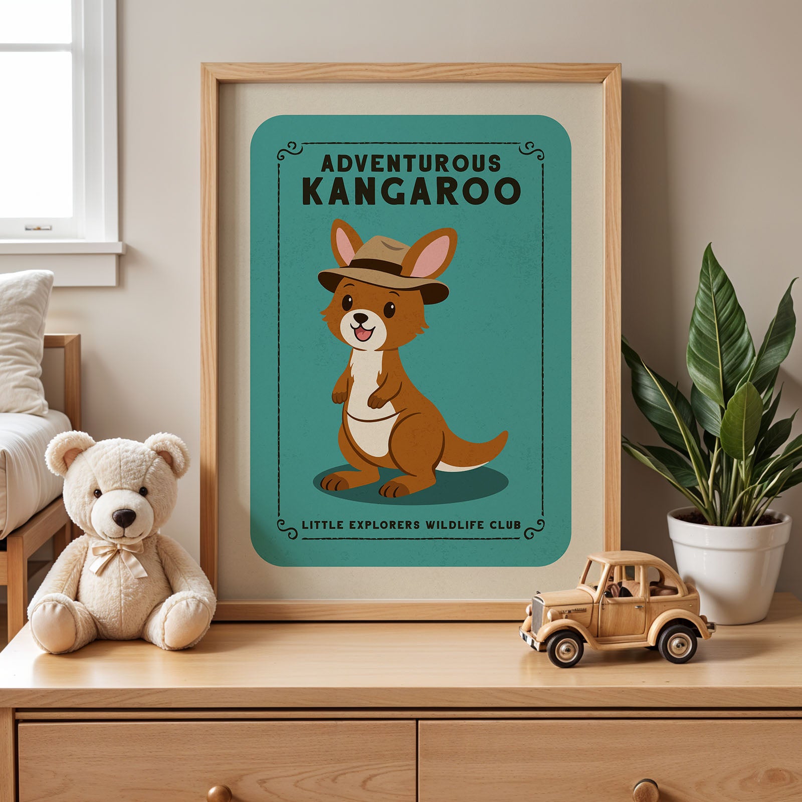 a framed poster of a kangaroo wearing a hat, placed on a wooden dresser next to a stuffed teddy bear and a toy truck.