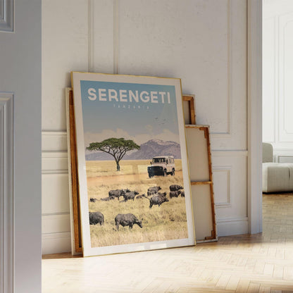 A framed poster of a safari scene in Serengeti National Park, Tanzania, featuring a herd of wildebeest grazing in the foreground.
