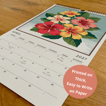 A wall calendar with a floral design and a printed statement about its thickness and ease of writing on paper.