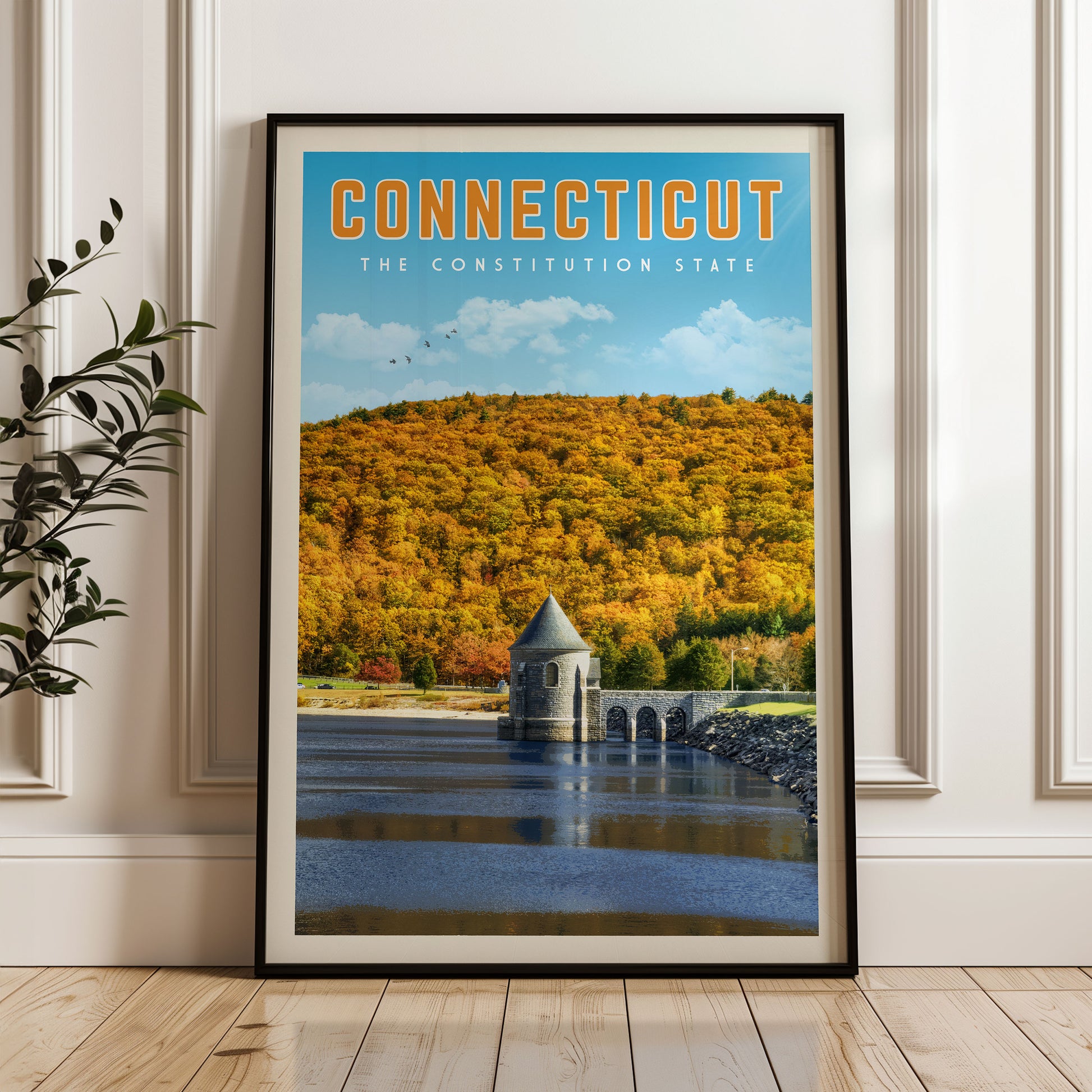 The image is a framed poster of a scenic landscape in Connecticut, featuring a picturesque view of a lake surrounded by a forest with autumn foliage.