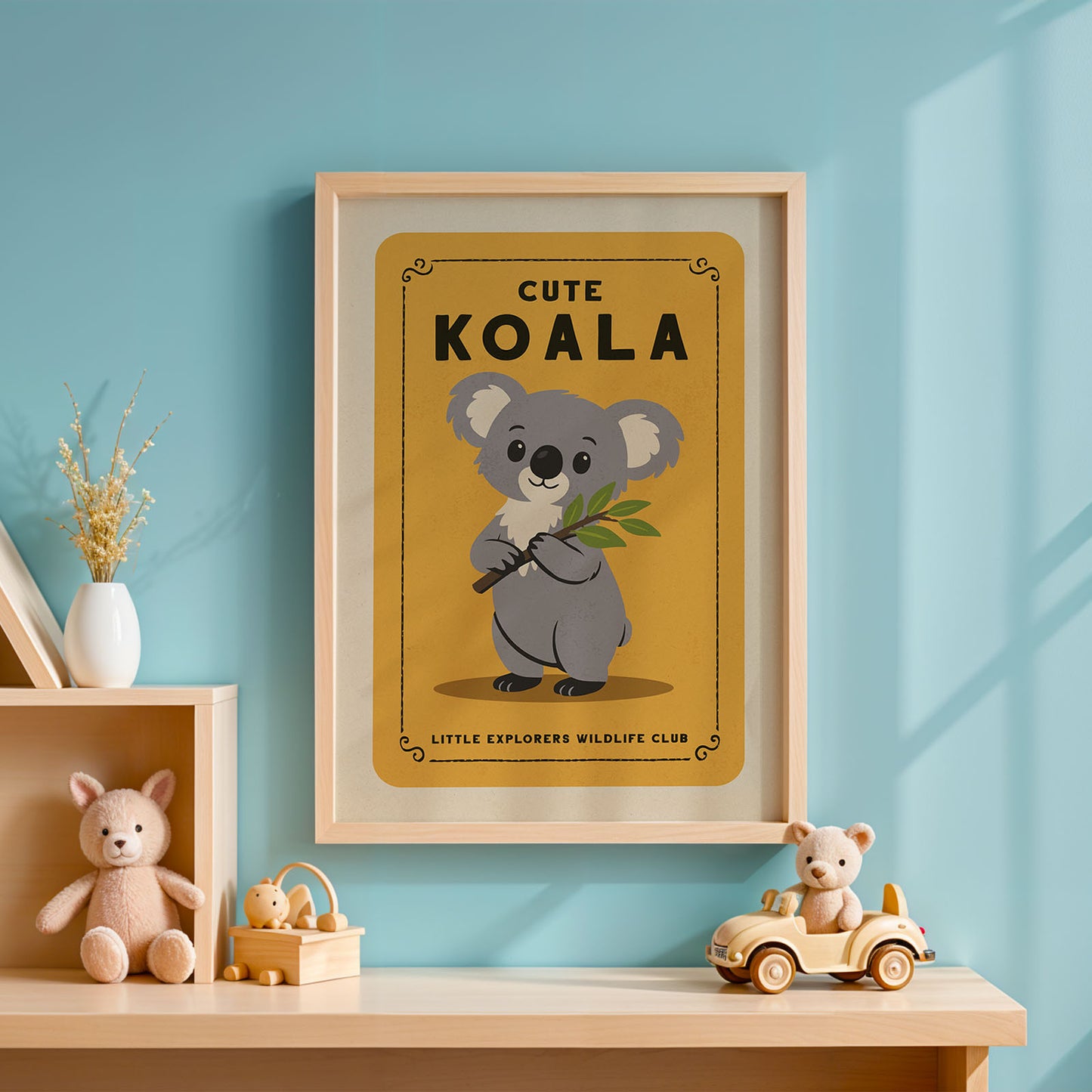 a framed poster of a koala bear with the text "CUTE KOALA" and "LITTLE EXPLORERS WILDLIFE CLUB" on it, hanging on a blue wall. Below the koala, there is a small wooden toy car.