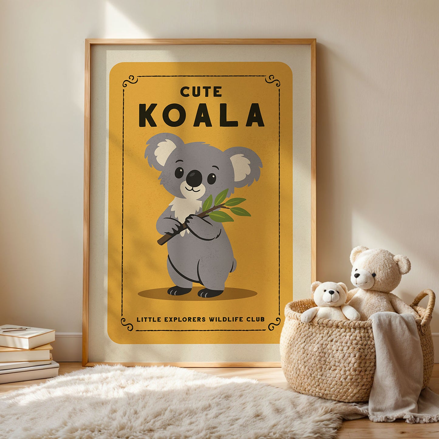 a framed poster of a koala bear with a yellow background and black text, accompanied by a woven basket containing two stuffed koala bears.