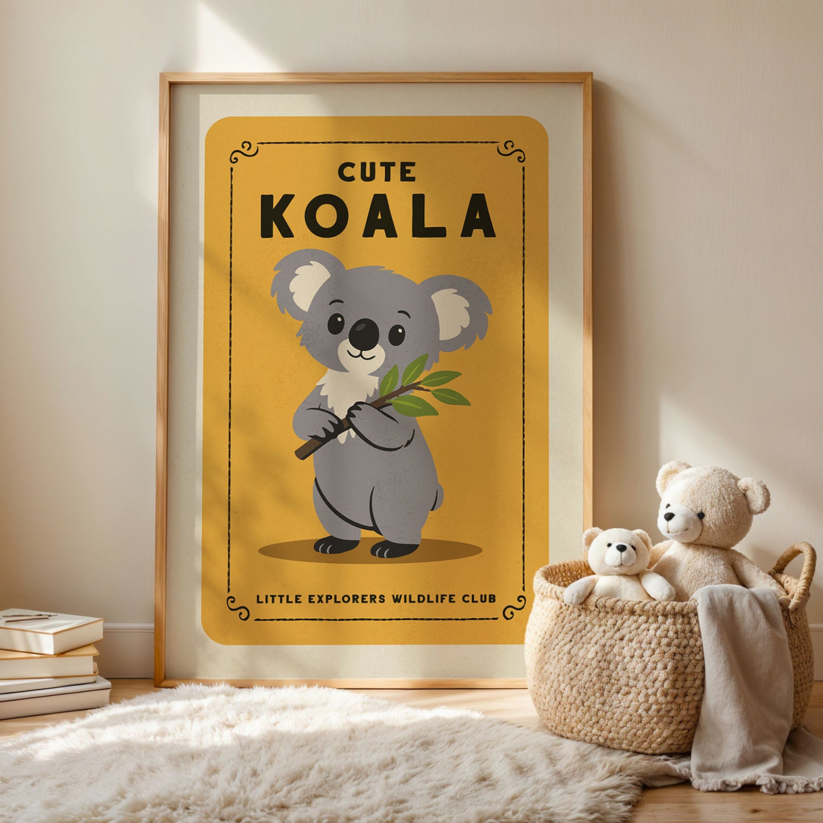 a framed poster of a koala bear with a yellow background and black text, accompanied by a woven basket containing two stuffed koala bears.