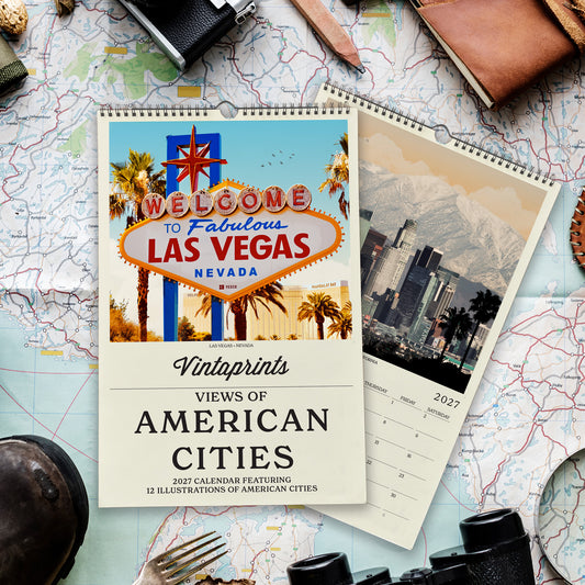 a calendar with a vibrant image of the Las Vegas Strip and the iconic sign, surrounded by various travel-related items such as a map, a camera, and a pair of binoculars.