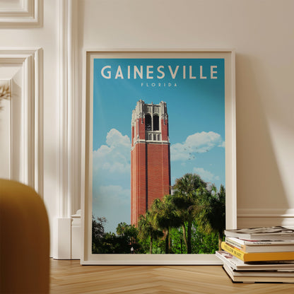 A framed poster of the Gainesville, Florida bell tower, with a clear blue sky and palm trees in the background.