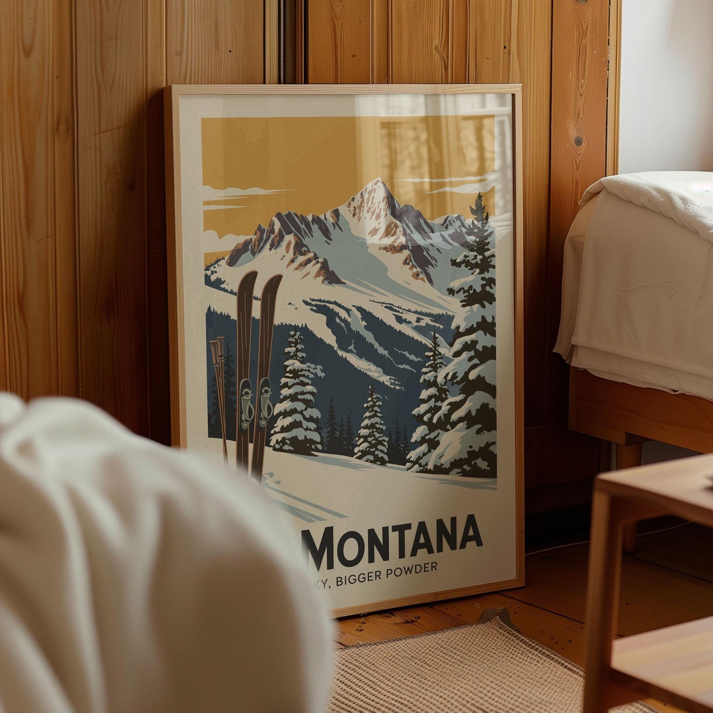 A framed poster of a snowy mountain landscape with skis in the foreground, displayed in a room with wooden walls.