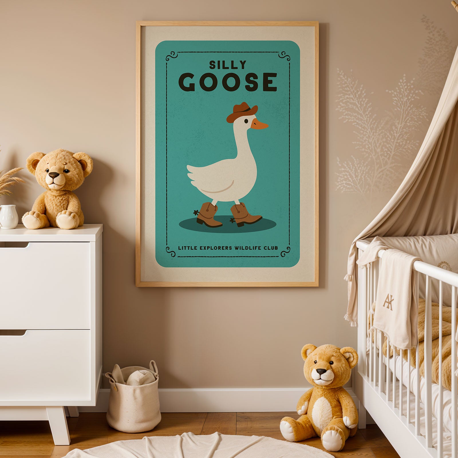A framed poster of a cartoon goose, labeled "Silly Goose", is displayed in a nursery room with a teddy bear and a crib.