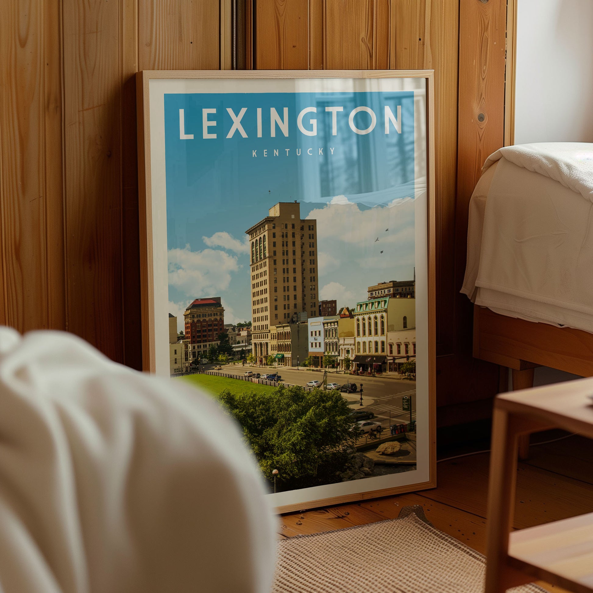 A framed poster of a cityscape in Lexington, Kentucky, with a tall building and other buildings visible in the background.