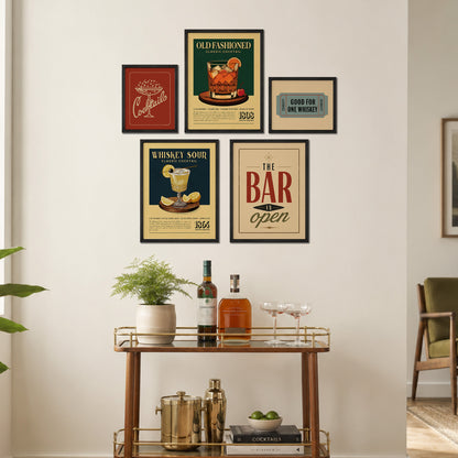 a wall display with framed vintage advertisements for whiskey, cocktails, and a bar, along with a wooden bar cart and various drinkware and accessories.