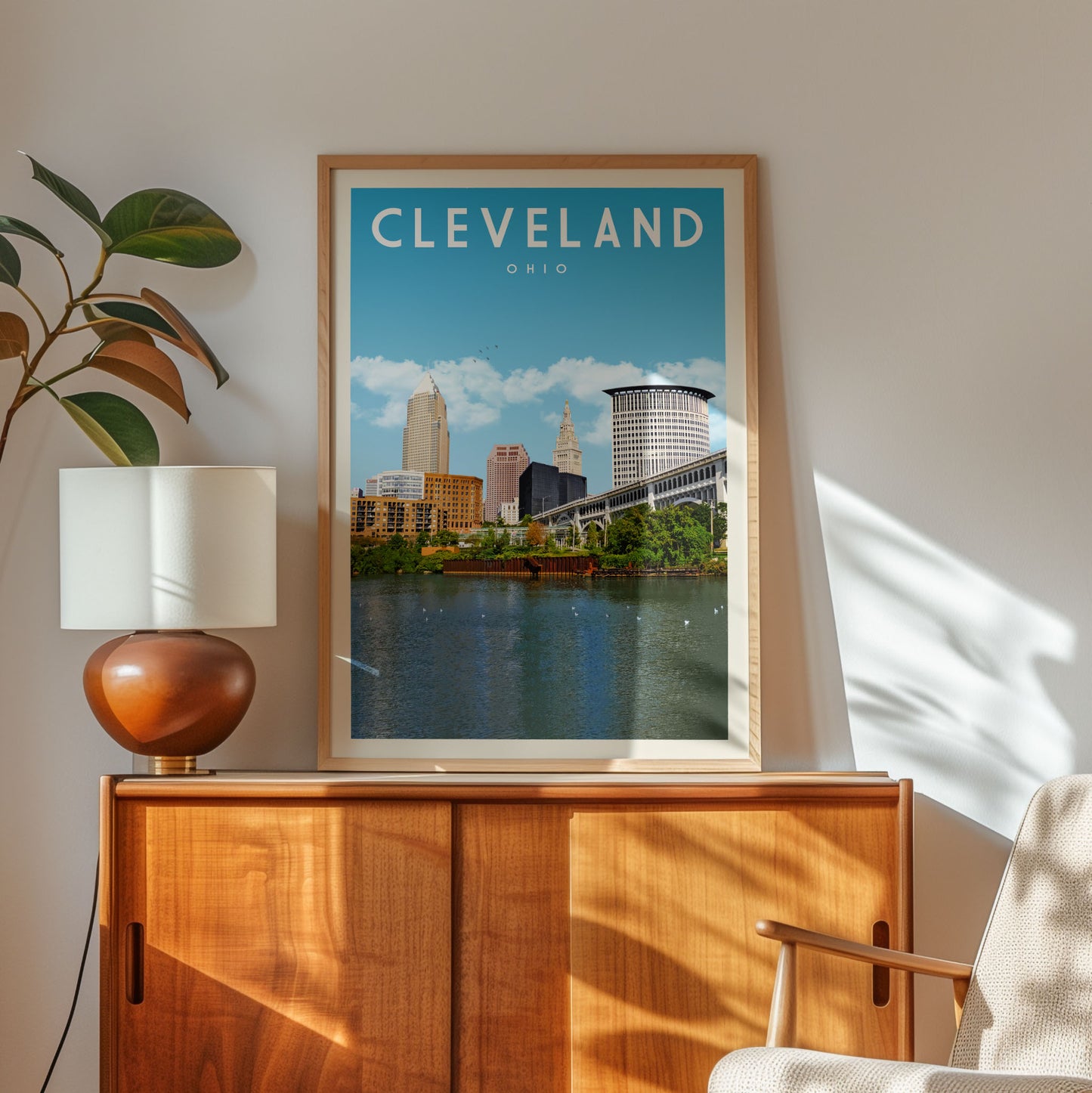 a framed poster of Cleveland, Ohio, with a view of the city's skyline and water.