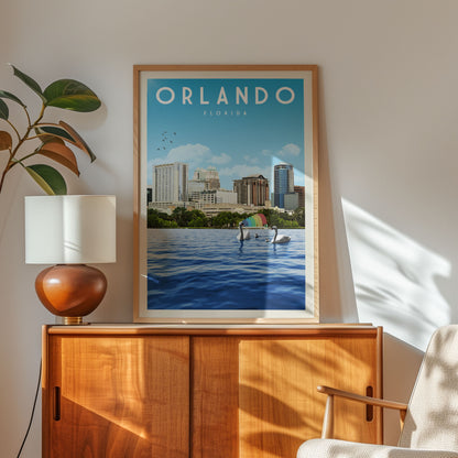 a framed poster of the Orlando skyline, with a cityscape and a boat on the water, hanging on a wall next to a wooden cabinet and a lamp.